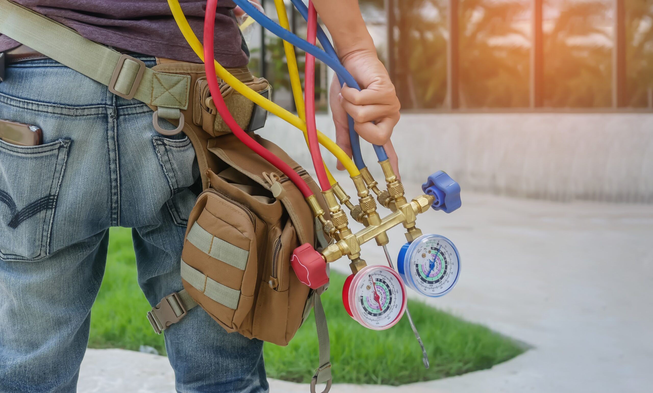 HVAC technician holding gauges