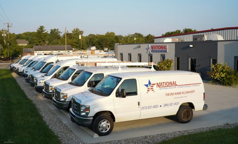 National service vans lined up in front of the National building.