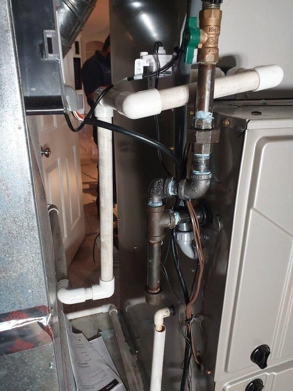 Completed full HVAC system replacement including installation of 926TC66120V24 96% AFUE variable-speed two-stage gas furnace, 135SAN06000W 5-ton single-stage air conditioner with R454B refrigerant rated at 14 SEER2, and CVAVA6024XMA v-coil cased vertical evaporator coil. Performed lineset flush with nitrogen, partial suction line replacement, and installed new disconnect box with fuses. Reconnected unit to existing flue pipes and gas line, retained existing thermostat, filter rack, and condenser pad, and verified all systems operational upon completion.