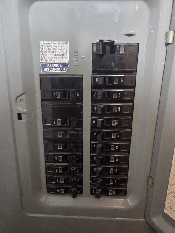 Conducted on-site evaluation for air conditioning system replacement. Assessed existing dual condenser unit configuration positioned on concrete pad adjacent to building exterior. Inspected electrical service panel containing approximately 20 circuit breakers with main disconnect, confirming adequate electrical capacity and proper service disconnect location for new equipment installation. Documented current HVAC equipment specifications and electrical infrastructure to provide comprehensive replacement estimate. Photographed existing condenser units and electrical panel for equipment sizing and installation planning purposes.