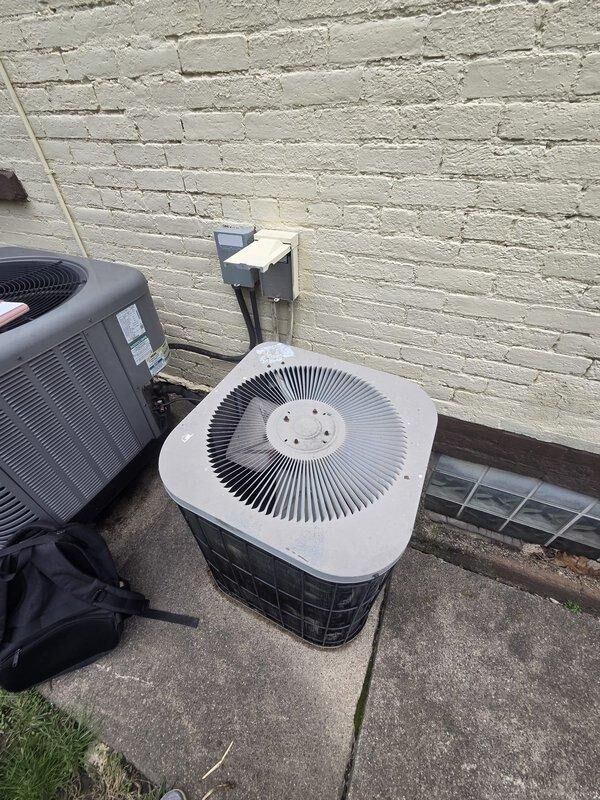 Conducted on-site evaluation for air conditioning system replacement. Assessed existing dual condenser unit configuration positioned on concrete pad adjacent to building exterior. Inspected electrical service panel containing approximately 20 circuit breakers with main disconnect, confirming adequate electrical capacity and proper service disconnect location for new equipment installation. Documented current HVAC equipment specifications and electrical infrastructure to provide comprehensive replacement estimate. Photographed existing condenser units and electrical panel for equipment sizing and installation planning purposes.