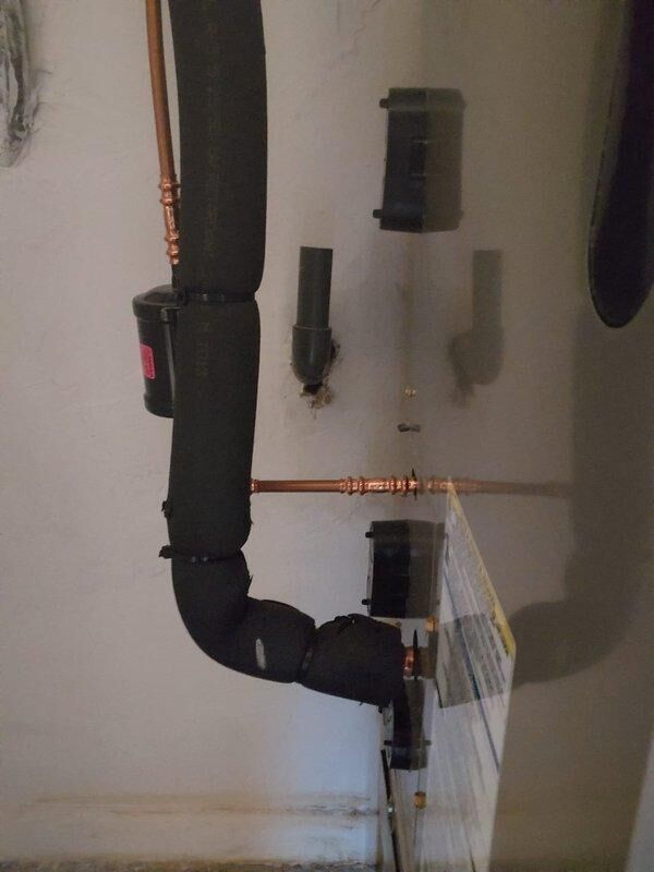 Responded to commercial HVAC installation callback to address incomplete condensate drain line that was not installed during original December installation. Installed proper PVC drain piping configuration and verified proper drainage flow. Checked system refrigerant charge using digital multimeter and found system low on refrigerant; added refrigerant to manufacturer specifications and verified proper voltage readings at 239.5V AC.