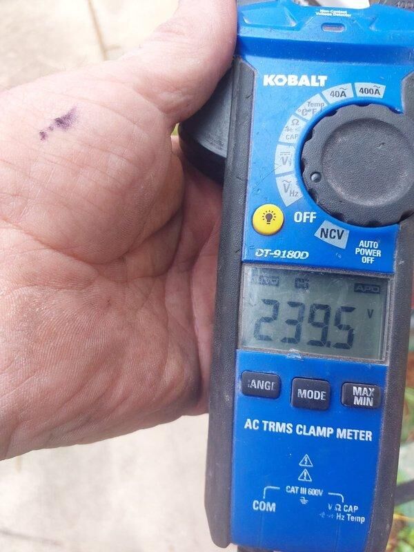 Responded to commercial HVAC installation callback to address incomplete condensate drain line that was not installed during original December installation. Installed proper PVC drain piping configuration and verified proper drainage flow. Checked system refrigerant charge using digital multimeter and found system low on refrigerant; added refrigerant to manufacturer specifications and verified proper voltage readings at 239.5V AC.