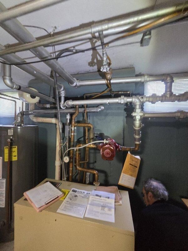 Conducted comprehensive site assessment of existing boiler system and associated hydronic heating distribution. Evaluated mechanical room equipment including boiler unit, piping infrastructure, pressure regulation components, and terminal heating units throughout the building. Documented current system configuration with photographic reference for estimate preparation.