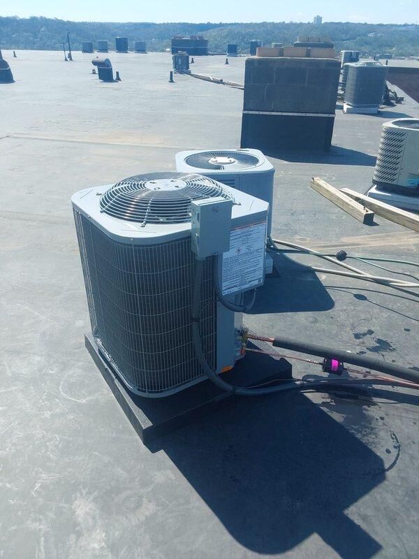 Completed full commercial HVAC system installation including BCRMA2124S3N3 water fan coil unit installed in interior utility closet and NCP5243000A through-wall AC unit with rooftop condenser. Connected new equipment to existing supply lines using copper piping and fittings, installed new thermostat for system control, and obtained necessary permits for the installation.