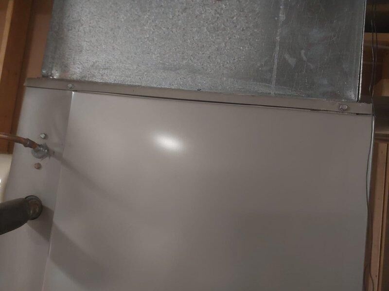 Returned to address inspection corrections on HVAC installation. Replaced improper rubber coupling on water heater blower with approved straight pipe section to meet code requirements. Installed missing gasket and hex screw on furnace as documented in previous inspection photos.