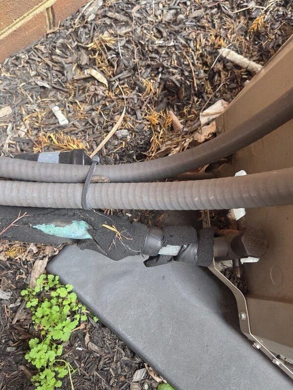 Conducted commercial AC replacement estimate for a rooftop unit at Extended Stay property. Inspected existing outdoor condenser unit mounted on concrete pad with adjacent electrical disconnect box, noting significant debris accumulation around flexible conduit/drain pipes requiring maintenance. Documented current system condition with photos to provide accurate replacement options suitable for the commercial application.