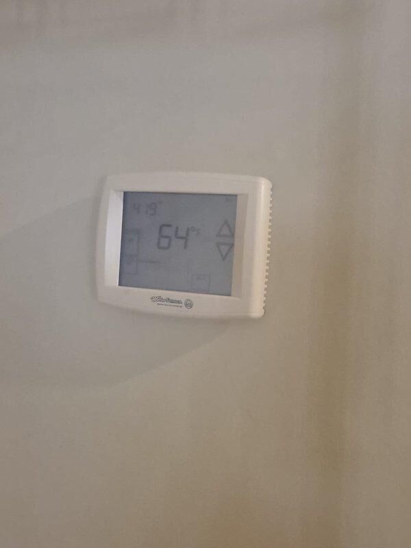 Conducted comprehensive assessment of 18-year-old geothermal system for potential replacement. Inspected existing thermostat installations (Comfort-Aire model showing 64-degree reading and another digital programmable unit) to evaluate compatibility with new system specifications. Provided detailed replacement estimate for complete geothermal system upgrade.