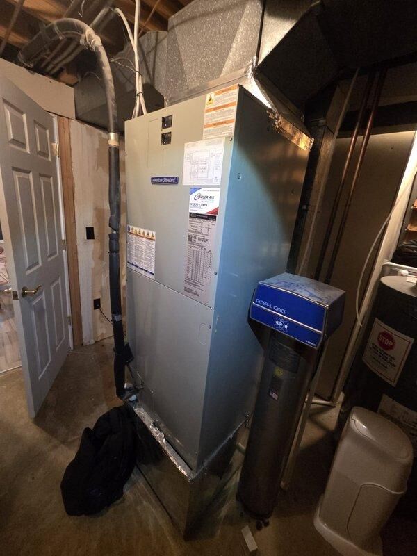 Conducted comprehensive assessment of existing HVAC system for potential replacement, including detailed inspection of furnace unit with connected ductwork and adjacent humidifier system. Documented current installation configuration with photographs, noting PVC drainage components, electrical connections, and overall condition of the heat pump and air handler setup in preparation for replacement estimate.