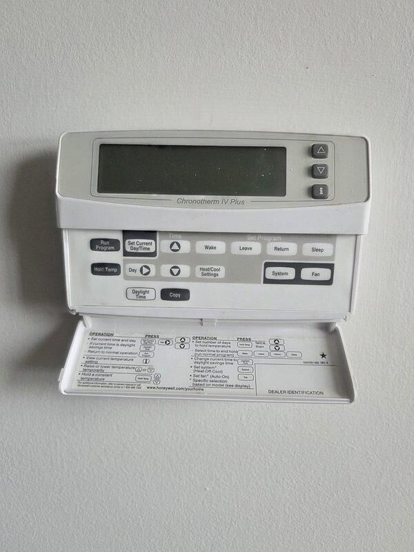 Conducted evaluation of aging HVAC system including a Honeywell Chronotherm IV Plus thermostat and basement-installed furnace unit with exposed internal components, ductwork, and PVC venting. Provided replacement estimate for complete system upgrade based on observed equipment condition and performance assessment.