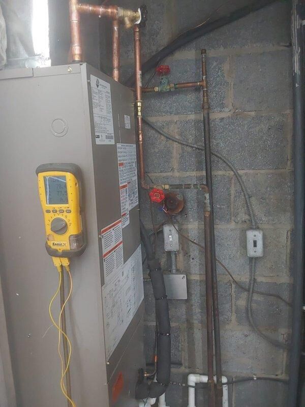 Completed full HVAC system installation for commercial application including one BCRMA2124S3N3 water fan coil unit installed in basement utility area with copper piping connections to existing water supply lines, one Bryant GA4SAN524 air conditioning condensing unit positioned on exterior equipment pad with electrical conduit and disconnect properly mounted to brick wall, new thermostat installation, and all necessary pipe fittings and connections. All equipment tested and verified operational, permit obtained, and system commissioned per manufacturer specifications.