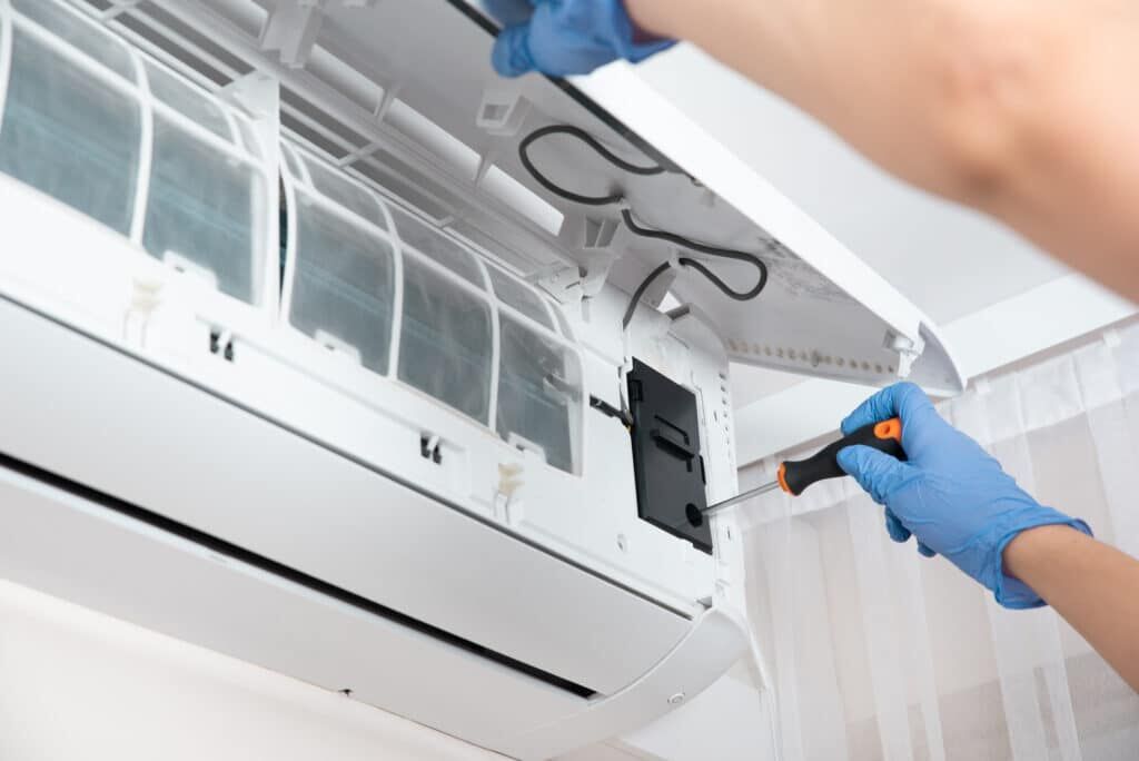 Technician working on ductless mini-split wall unit